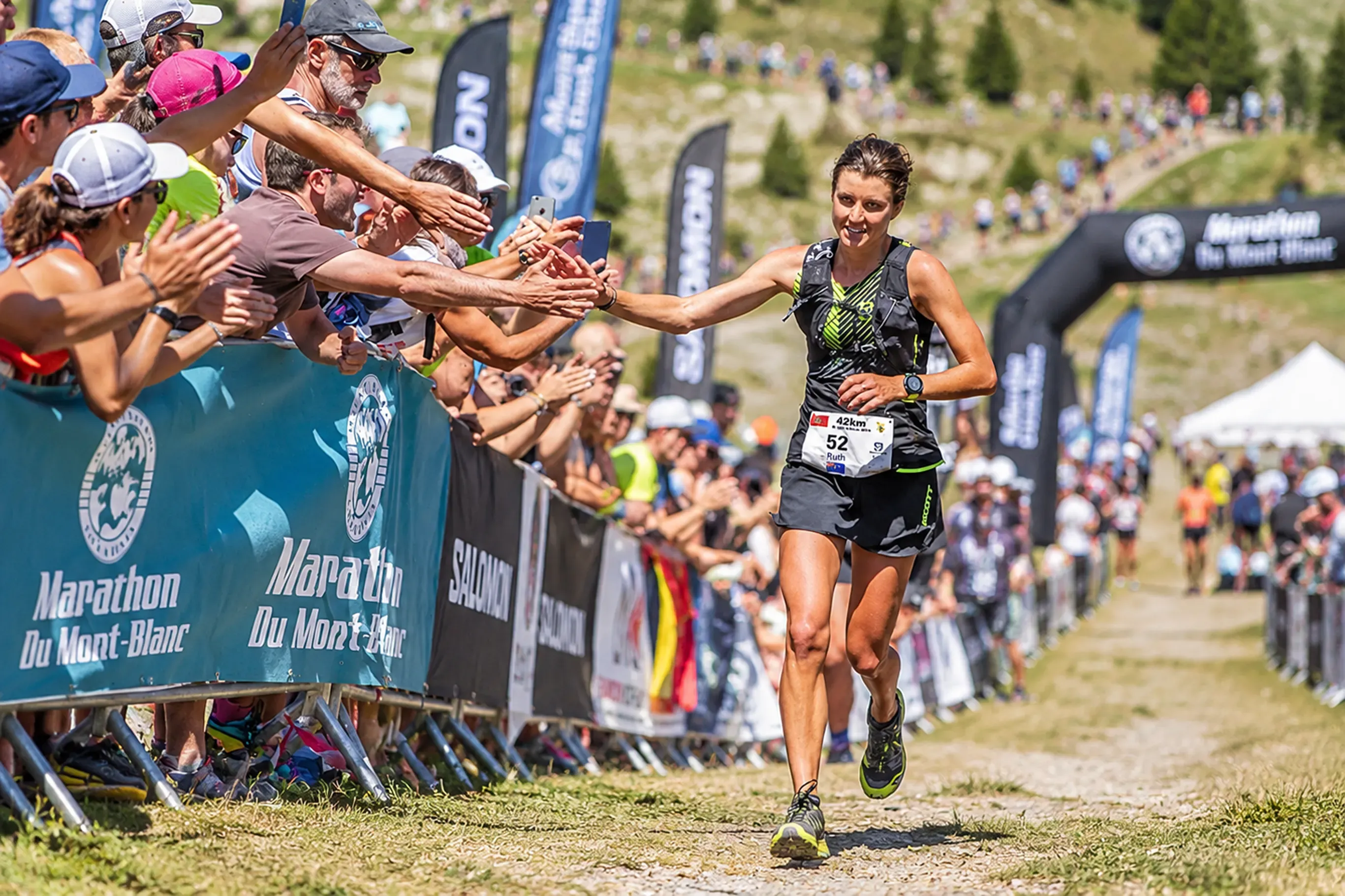 Trail runner preparing for an ultra-trail race on a high-mountain path